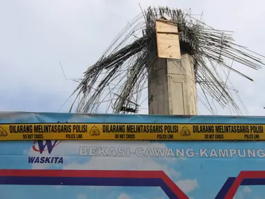 Lokasi ambruknya tiang girder proyek Tol Bekasi-Cawang-Kampung Melayu (Becakayu) dipasangi garis polisi, di dekat Gerbang Tol Kebon Nanas, Jakarta Timur, Selasa (20/2). Kejadian itu mengakibatkan tujuh orang pekerja terluka. (Liputan6.com/Arya Manggala)