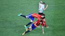 Pemain Spanyol, Gerard Pique dan Sergio Busquets, terjatih saat bereut bola dengan pemain Turki, Burak Yilmaz, pada laga Grup D Piala Eropa 2016 di Allianz Riviera, Nice, Sabtu (18/6/2016) dini hari WIB. (AFP/Bertrand Langlois)