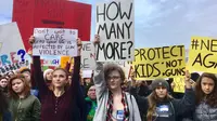 Sejumlah siswa dari Roosevelt High School membawa poster saat melakukan aksi di Seattle (14/3). Ini merupakan aksi terbesar pasca penembakan di sebuah SMA di Parkland, Florida, yang menewaskan 17 orang. (AP Photo / Manuel Valdes)