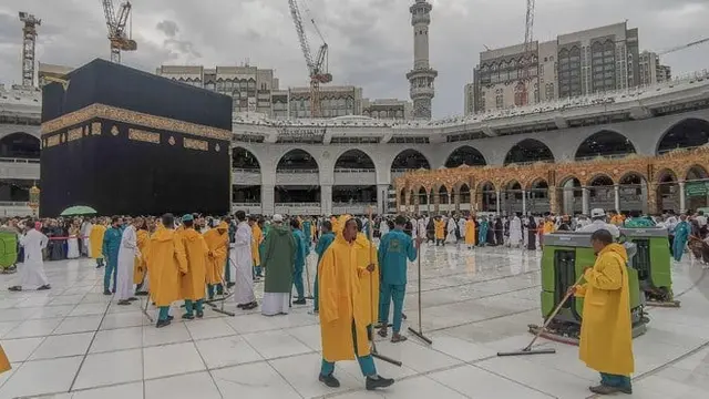 Pekerja di Masjidil Haram di Makkah membersihkan area Mataf dari air hujan. (Twitter @ReasahAlharmain)