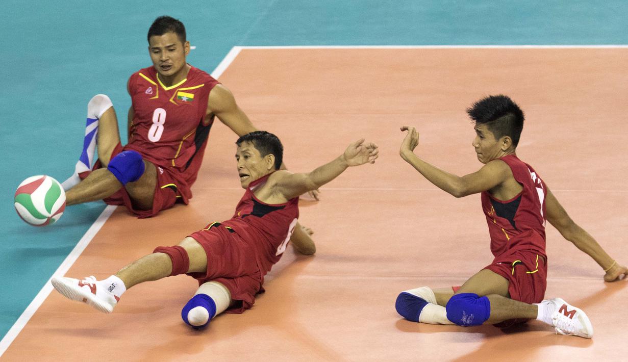 Ko Ko Naing asal Myanmar berusaha mengembalikan bola dalam laga semifinal voli duduk melawan Jepang pada Asian Para Games di Tennis Indoor Gelora Bung Karno Jakarta, Rabu (10/10/2018). (Bola.com/Peksi Cahyo)