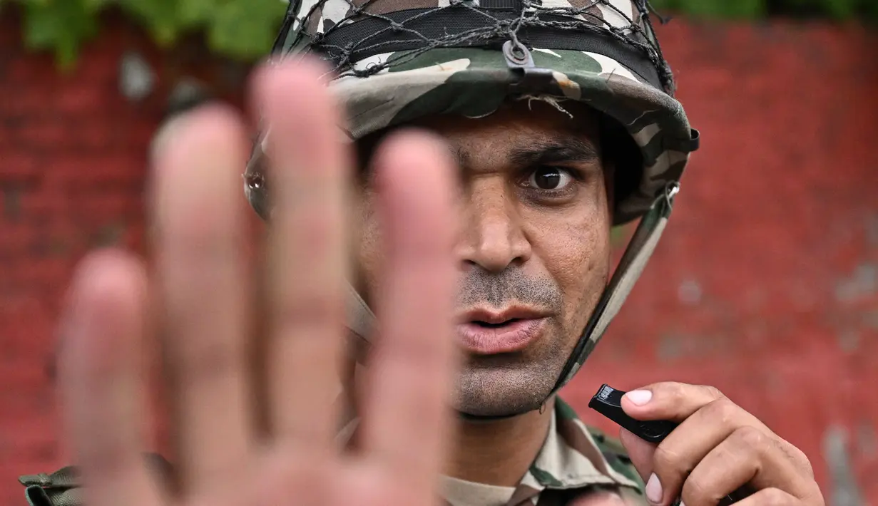 Personel militer memberi isyarat saat berjaga-jaga di sepanjang jalan selama jam malam yang diberlakukan untuk memulihkan ketertiban dan keamanan di Kathmandu, Nepal pada 12 September 2025. (Pedro Pardo/AFP)