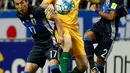 Pemain Australia, Tomi Juric berebut bola dengan dua pemain Jepang, Yosuke Ideguchi (kanan) dan Jepang Makoto Hasebe saat pertandingan kualifikasi Piala Dunia Grup B di Saitama, Jepang (1/9). (AP Photo / Shuji Kajiyama)