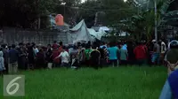 Warga berkerumun untuk melihat helikopter yang jatuh di Dusun Kowang, Sleman (8/7). Heli jatuh setelah melakukan penerbangan dari Solo menuju Yogyakarta. (Liputan6.com/Boy Harjanto)