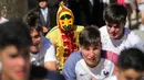 Pria berkostum setan mengejar kerumunan orang selama festival melompati bayi (El Colacho) di desa Castrillo de Murcia, Minggu (18/6). Festival ini dimulai ketika kerumunan orang termasuk para orang tua dari bayi-bayi  sudah berkumpul. (CESAR MANSO/AFP)