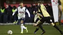 Gelandang Tottenham Hotspur, Lucas Moura dan pemain Marine, James Devin bersaing memperbutkan bola dalam babak ketiga Piala FA di Rossett Park, Crosby, Inggris, Minggu (10/1/2021). Tottenham Hotspur tanpa ampun menggilas tim semi-profesional, Marine dengan 5-0. (Clive Brunskill/Pool via AP)