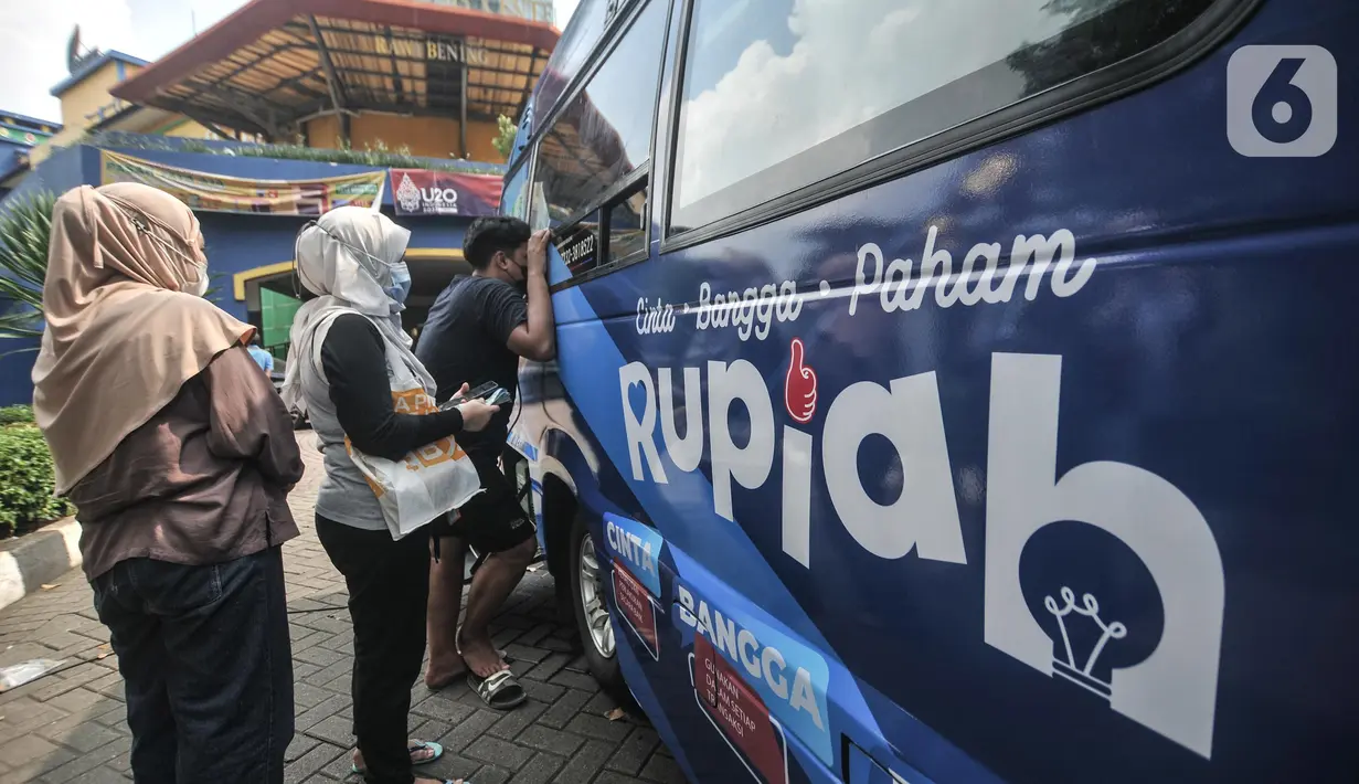 Warga menukarkan uang pecahan kecil di mobil Kas Keliling BI, Pasar Rawa Bening, Jakarta Timur, Senin (18/4/2022). Untuk mencegah virus corona, BI meminta masyarakat mendaftar melalui aplikasi Pintar BI di https://pintar.bi.go.id sebelum ke mobil kas keliling BI. (merdeka.com/Iqbal S.Nugroho)