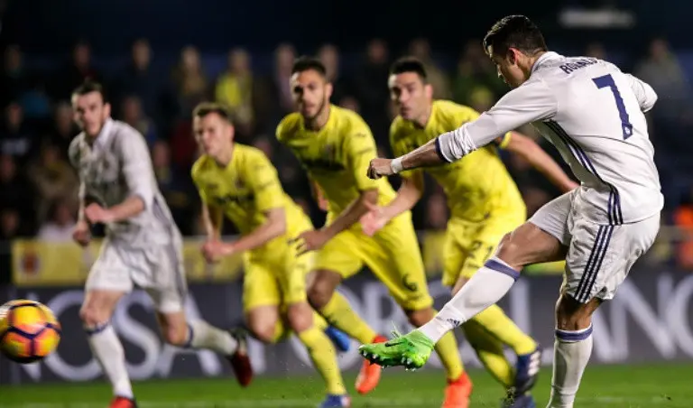 Striker Real Madrid Cristiano Ronaldo mengeksekusi penalti ke gawang Villarreal pada laga La Liga di El Madrigal, Villarreal, Minggu (26/2/2017). (AFP/Biel Alino)