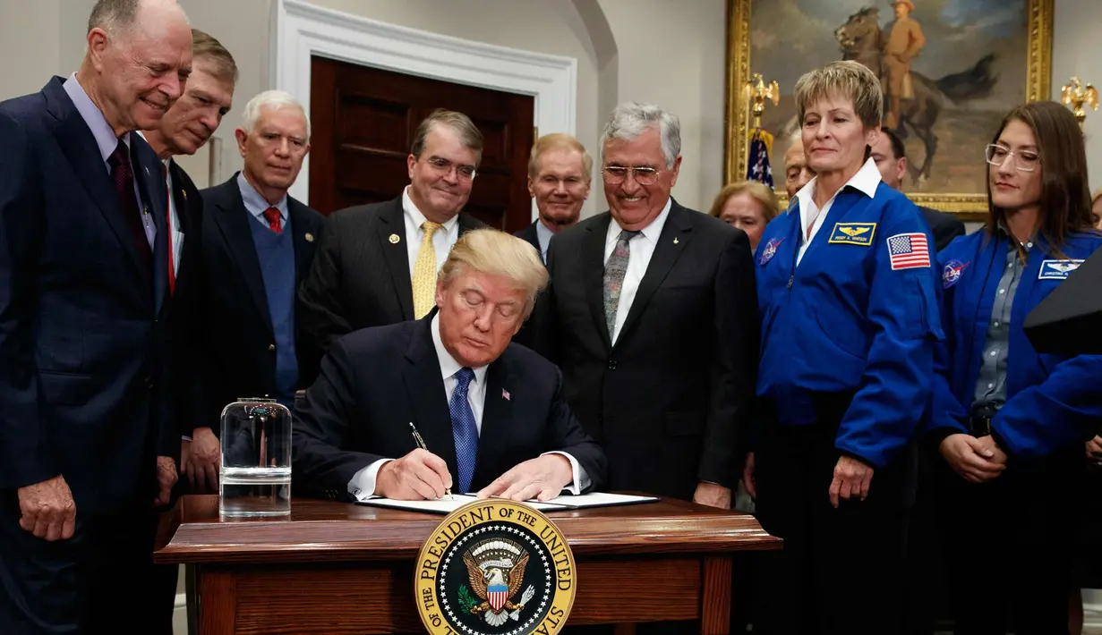 Presiden AS, Donald Trump menandatangani dokumen kebijakan untuk mengirim astronot AS kembali ke bulan dan Mars, di Ruang Roosevelt Gedung Putih, di Washington (11/12). (AP Photo/Evan Vucci)