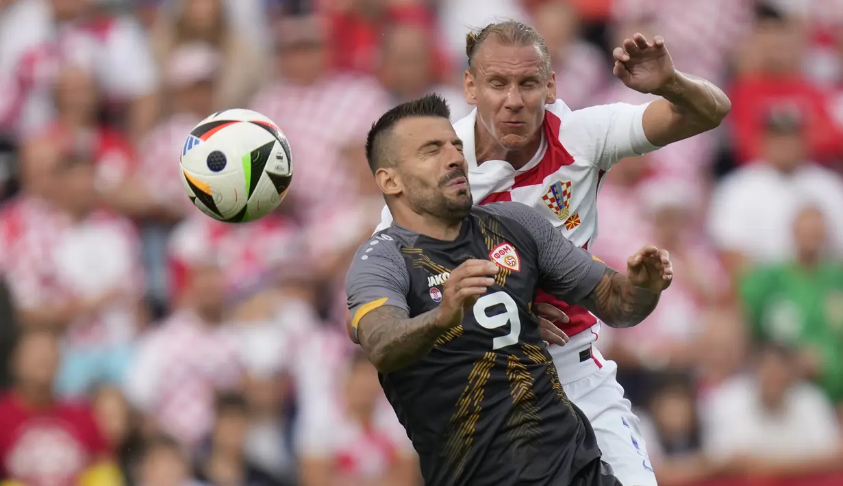 Bek Kroasia Domagoj Vida melompat untuk melakukan sundulan dengan penyerang Makedonia Utara  Aleksandar Trajkovski pada laga uji coba internasional menjelang Piala Eropa 2024 di stadion Rujevica Selasa (4/6/2024) dini hari. (AP Photo/Darko Bandic)