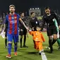 Murtaza Ahmadi mendampingi Lionel Messi memasuki lapangan sebelum laga persahabatan melawan Al Ahli di Doha, Selasa (13/12/2016). (AFP)