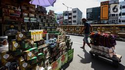 Seorang pria melewati kios pedagang kurma di kawasan Tanah abang, Jakarta, Minggu (3/4/2022). Omset penjualan kebutuhan bulan Ramadhan seperti perlengkapan ibadah dan buah kurma kembali meningkat dibandingkan dua tahun terakhir yang terdampak pandemi COVID-19. (Liputan6.com/Johan Tallo)