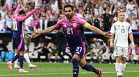 Gelandang timnas Jerman, Ilkay Gundogan, merayakan gol yang dicetaknya ke gawang Hungaria dalam laga Grup A Euro 2024 di Stuttgart Arena, Rabu (19/6/2024) malam WIB. (THOMAS KIENZLE / AFP)