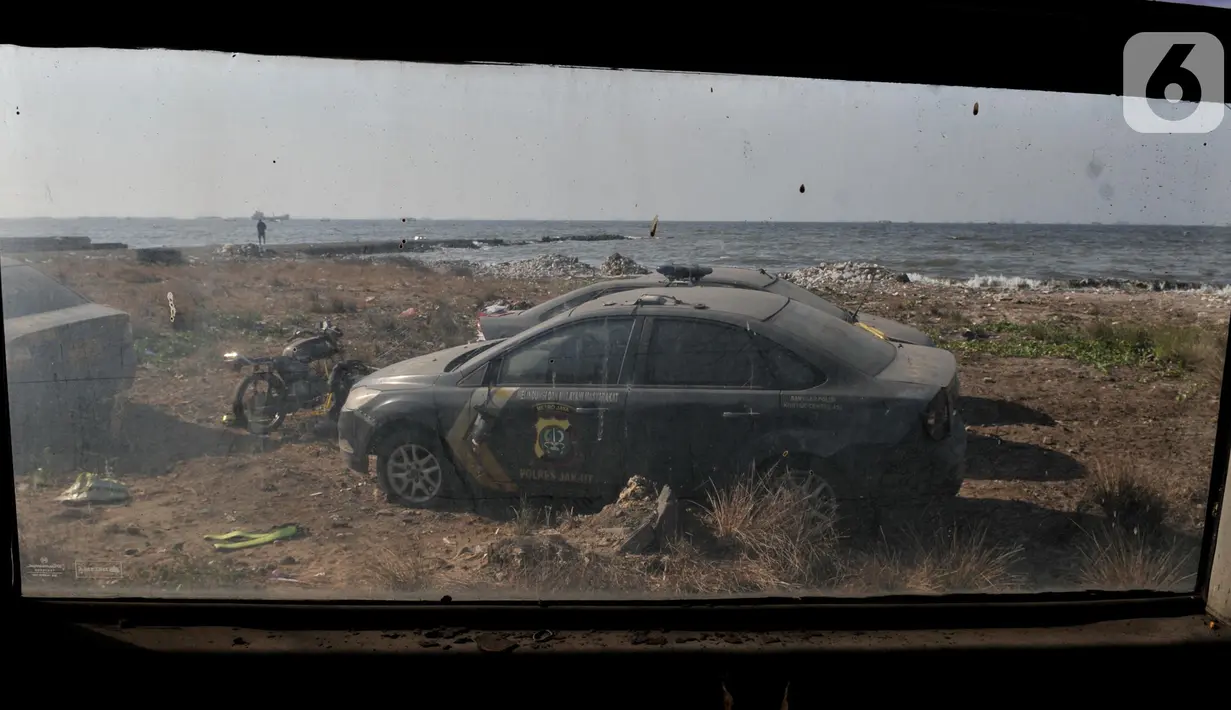 Kondisi kendaraan dinas Polres Jakarta Utara saat berada di pesisir Marunda, Selasa (22/10/2019). Puluhan kendaraan bermotor yang terdiri dari mobil, bus dan motor tersebut sengaja ditempatkan di pesisir karena sudah rusak dan tak dapat lagi digunakan. (merdeka.com/Iqbal Nugroho)