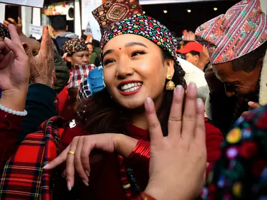 Seorang wanita anggota komunitas adat Gurung menari mengenakan pakaian tradisional saat mengikuti upacara perayaan Tahun Baru 'Tamu Lhosar' di Kathmandu, Nepal (30/12/2022). Acara itu digelar untuk menyambut pergantian tahun. (AFP/Prakash Mathema)