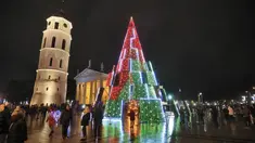 Pohon Natal yang menyala terlihat di dekat katedral di Vilnius, Lithuania pada 28 November 2020. Pohon natal raksasa yang dihiasi berbagai ornamen lampu hias tersebut membuat kawasan di ibu kota Lithuania menjadi terang. (PETRAS MALUKAS / AFP)