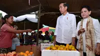 Presiden Joko Widodo ditemani Ibu Negara Iriana membeli buah-buahan saat meninjau rencana revitalisasi Pasar Sukawati di Gianyar, Bali, Jumat (14/6/2019). Jokowi melihat rencana proyek revitalisasi Pasar Sukawati sekaligus berinteraksi dengan pedagang. (Liputan6.com/Pool/Biro Pers Setpres)