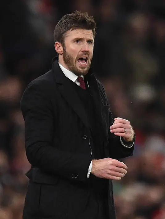 Legenda lini tengah Old Trafford itu akan memimpin The Red Devils hingga akhir musim ini. Tampak dalam foto, Michael Carrick saat masih menjadi pelatih sementara Manchester United memberi isyarat di pinggir lapangan selama pertandingan sepak bola Liga Premier Inggris melawan Arsenal di Old Trafford, Manchester, Inggris barat laut, pada 2 Desember 2021. (Oli SCARFF/AFP)