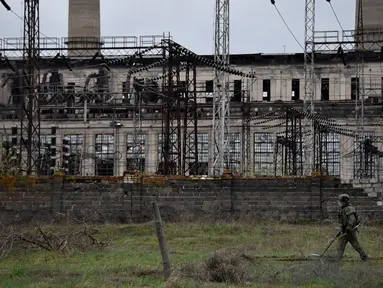 Seorang tentara Rusia menjinakkan pembangkit listrik Luhansk di kota Shchastya (13/4/2022). Pembangkit listrik Luhansk adalah pembangkit listrik termal di utara Shchastia, dekat Luhansk, Ukraina. (AFP/ Alexander Nemenov)