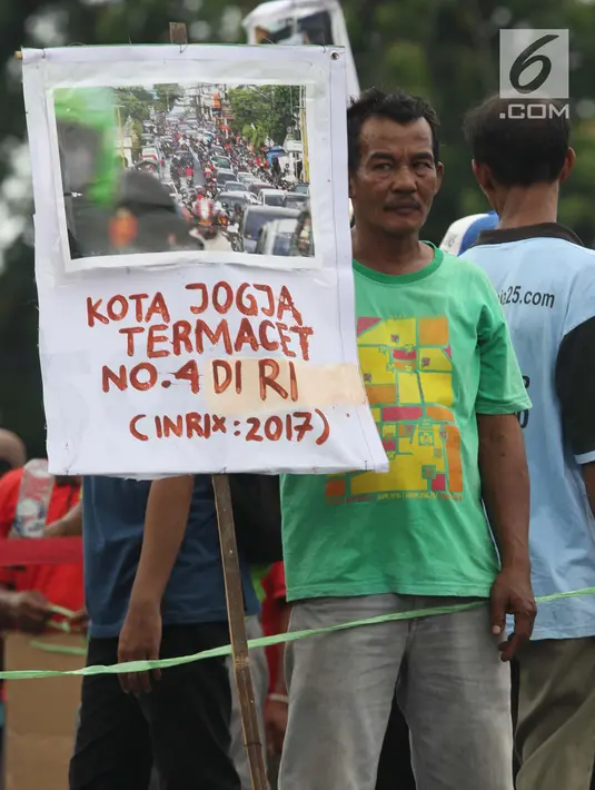 Kelompok pengemudi becak motor bersama aktivis melakukan aksi di titik Nol kilometer Yogyakarta, Senin (22/4). Aksi memperingati Hari Bumi ini diisi dengan ajakan kepada masyakarat untuk mengurangi sampah dan penggunaan plastik. (Liputan6.com/Helmi Fithriansyah)