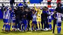 Para pemain Alcoyano melakukan selebrasi usai menaklukkan Real Madrid pada laga Copa del Rey di Stadion El Collao, Rabu (20/1/2021). Real Madrid takluk dengan skor 2-1. (AP/Jose Breton)