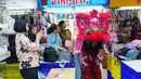 Tidak sedikit pengunjung yang berhenti sejenak untuk menyaksikan pertunjukan, bahkan mengabadikan momen tersebut melalui telepon genggam mereka. Tampak dalam foto, seorang penari barongsai tampil di Pusat Perbelanjaan Senen, Jakarta, Kamis 12 Februari 2026. (AP Photo/Tatan Syuflana)