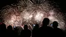 Penonton menyaksikan pertunjukan kembang api dari salah satu peserta pada puncak kompetisi Pyromusical Internasional ke-9 di Filipina, Sabtu (24/3). Tim kembang api Jerman dan Inggris memenangkan festival kembang api internasional ini. (AP/Bullit Marquez)