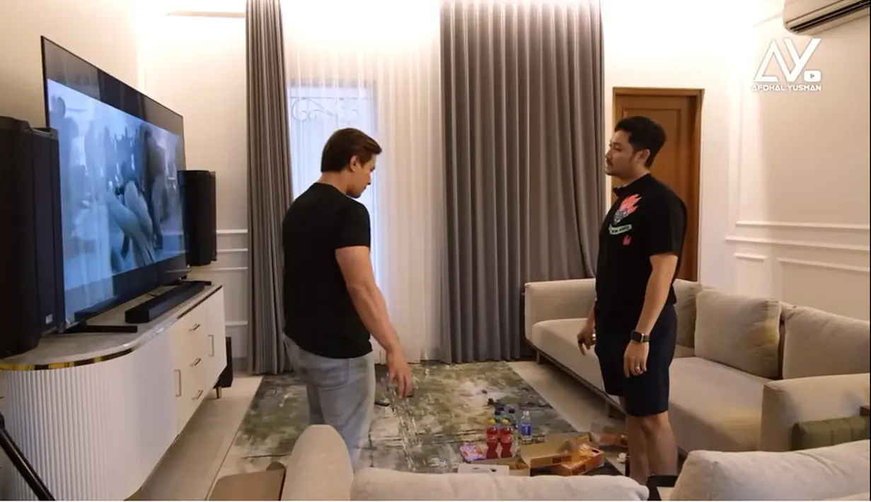 Ruang living room yang biasa digunakan untuk menghabiskan waktu bersama keluarga. Terdapat dua sofa panjang dan layar teve besar sebagai sarana hiburan. [Youtube/Afdhal Yusman]