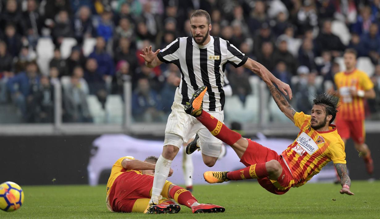 Striker Juventus, Gonzalo Higuain, menghindari penjagaan pemain Benevento pada laga Serie A Italia di Stadion Allianz, Turin, Minggu (5/11/2017). Juventus menang 2-1 atas Benevento. (AFP/Miguel Medina)