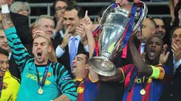 Bek Barcelona asal Prancis Eric Abidal (kanan) mengangkat trofi Liga Champions usai mengalahkan Manchester United dalam partai final di Wembley Stadium, 28 Mei 2011. AFP PHOTO/CARL DE SOUZA