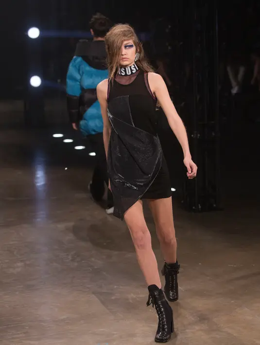 Gaya Gigi Hadid berjalan di atas catwalk saat mengenakan busana brand Versus Versace di atas panggung London Fashion Week di Inggris, (18/2). Gigi Hadid tampil mempesona dengan gaya urakannya. (Foto oleh Joel Ryan / Invision / AP)