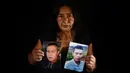 Lucila Huila, ibu dua dari enam pria Kolombia yang dibantai oleh terduga kelompok bersenjata pada 21 Agustus di El Tambo, berpose dengan foto putranya Heine Collazos, 25, dan Esneider Collazos, 23, di Popayan pada 28 Agustus 2020. Pembunuhan kembali berdarah di pedesaan Kolombia. (Luis ROBAYO/AFP)