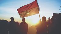 Ilustrasi bendera Indonesia. (Photo by crysia . on Unsplash)