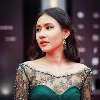 Shenina Cinnamon tak selalu tampil kasual. Sesekali ia bergaya glamor dalam balutan gaun brokat dan sematan perhiasan menawan, seperti saat ia menghadiri FFI 2021. Nuansa emerald terlihat cantik dengan warna kulit sawo matang yang dimilikinya. (Foto: Instagram)