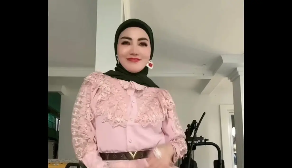 Bella Shofie tampil mengenakan ruffled dress warna pink gradasi hijau, dipadukan pashmina hitam, dan ikat pinggang warna senada. (Instagram/bellashofie_rigan).