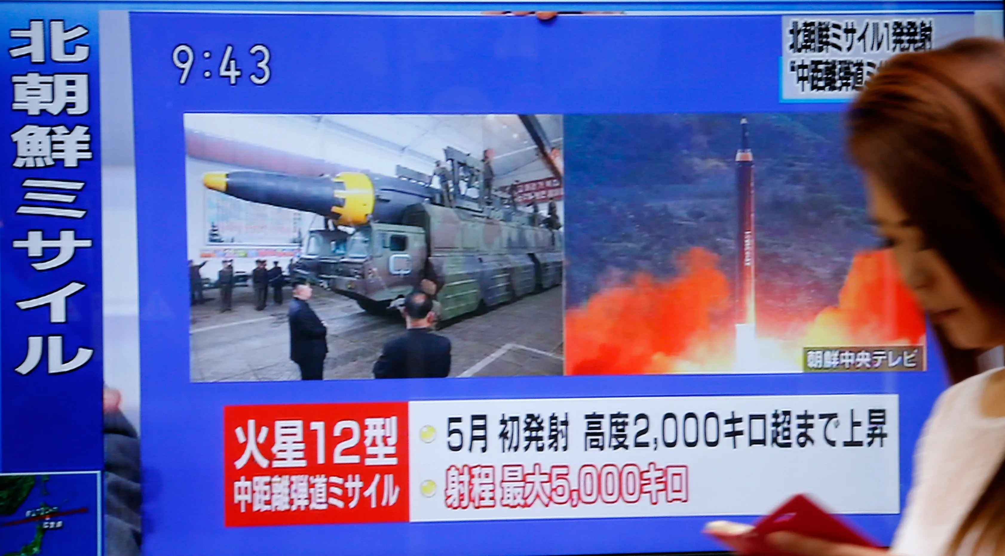 Seorang wanita berjalan melewati sebuah layar TV yang menyiarkan peluncuran rudal Korea Utara di Tokyo, Jepang, Selasa (29/8). Sejak Kim Jong-un berkuasa pada akhir 2011, Korut telah melakukan lebih dari 80 kali uji coba rudal. (AP/Shizuo Kambayashi)
