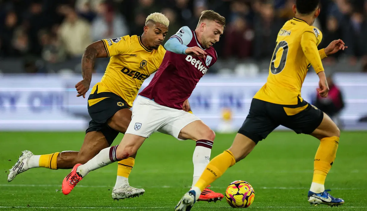 Pemain West Ham United, Jarrod Bowen berusaha melewati kawalan dari pemain Wolves pada laga lanjutan Liga Inggris 2024/2025 di London Stadium, London, Inggris, Selasa (10/12/2024) WIB. (AFP/Adrian Dennis)