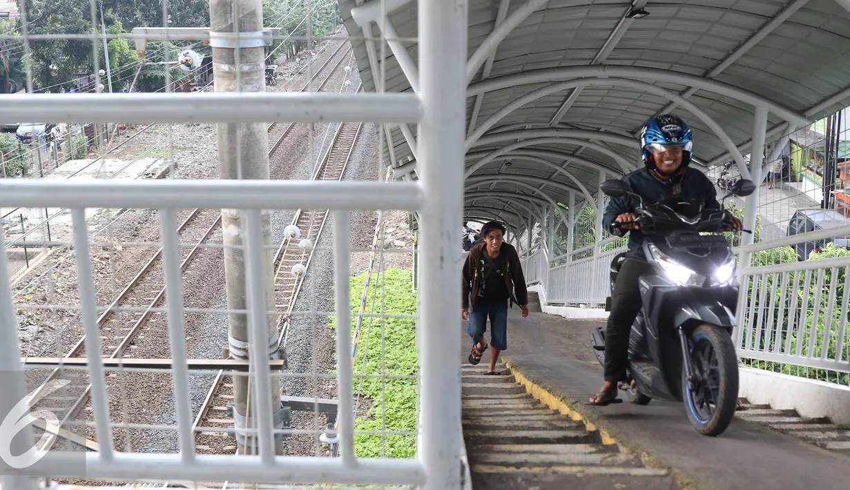 Pengendara motor melintas di jembatan penyeberangan orang (JPO) di kawasan Pasar Minggu, Jakarta, Selasa (6/9). JPO yang seharusnya diperuntukkan bagi pejalan kaki, kini seringkali digunakan pemotor untuk menyeberang. (Liputan6.com/Immanuel Antonius)