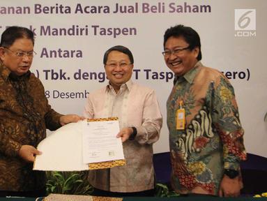 Wadirut Bank Mandiri Sulaiman Arif Arianto (tengah) dan Dirut Taspen Iqbal Latanro (kiri) menunjukkan dokumen penguatan modal Bank Mantap disaksikan Dirut Bank Mantap Josephus Koernianto Triprakoso, Jakarta, Selasa (18/12). (Liputan6.com/Angga Yuniar)