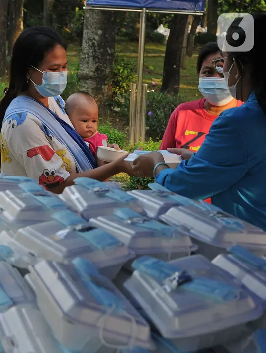 Mahasiswa memberikan makanan gratis kepada masyarakat di UKI, Cawang, Jakarta, Selasa (16/3/2021). Kegiatan ini memberikan 500 bungkus nasi, masker dan vitamin setiap harinya sejak pukul 06.00 WIB, untuk meringankan beban masyarakat di masa pandemi Covid-19. (Liputan6.com/Herman Zakharia)