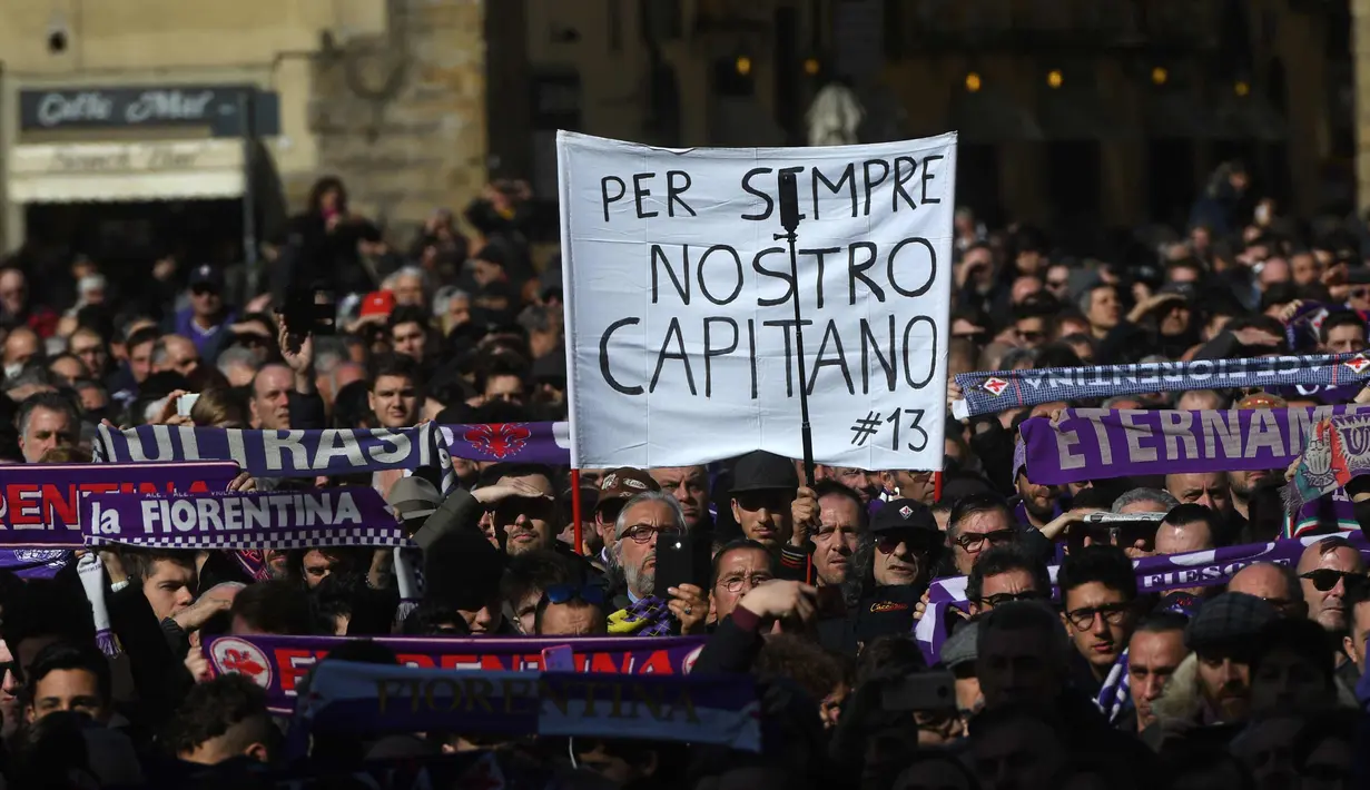 Suporter Fiorentina membentangkan syal saat mengantar jenazah kapten Fiorentina Davide Astori pada upacara pemakaman di Florence, Italia (8/3). Davide Astori meninggal pada usia 31 tahun. (AP Photo/Alessandra Tarantino)