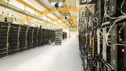 Seorang teknisi melakukan perawatan pada rig pertambangan dari komputer super di dalam pabrik bitcoin 'Genesis Farming' di dekat Reykjavik, Islandia (16/3). (AFP Photo/Halldor Kolbeins)