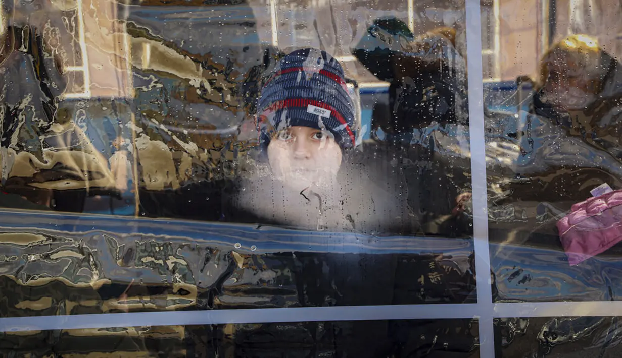 Napas anak-anak mengaburkan lembaran plastik pada tenda triase tempat orang-orang yang melarikan diri dari Ukraina menunggu setelah melintasi perbatasan di Palanca, Moldova, 4 Maret 2022. (AP Photo/Aurel Obreja)