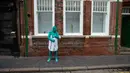 Seorang model memakai kardus menutupi tubuhnya usai mengikuti sesi foto menjadi model sebuah seni berjudul "Sea of Hull" karya Spencer Tunick asal Amerika Serikat di pusat Kota Hull, Inggris, Sabtu (9/7). (AFP Photo/Jon Super)