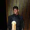 Penyerang muda Barcelona, Lamine Yamal, menerima Kopa Trophy, lambang pemenang predikat pemain muda terbaik di seremonial Ballon d'Or yang berlangsung di Theatre du Chatelet di Paris, Senin (28/10/2024) malam waktu setempat. (FRANCK FIFE / AFP)