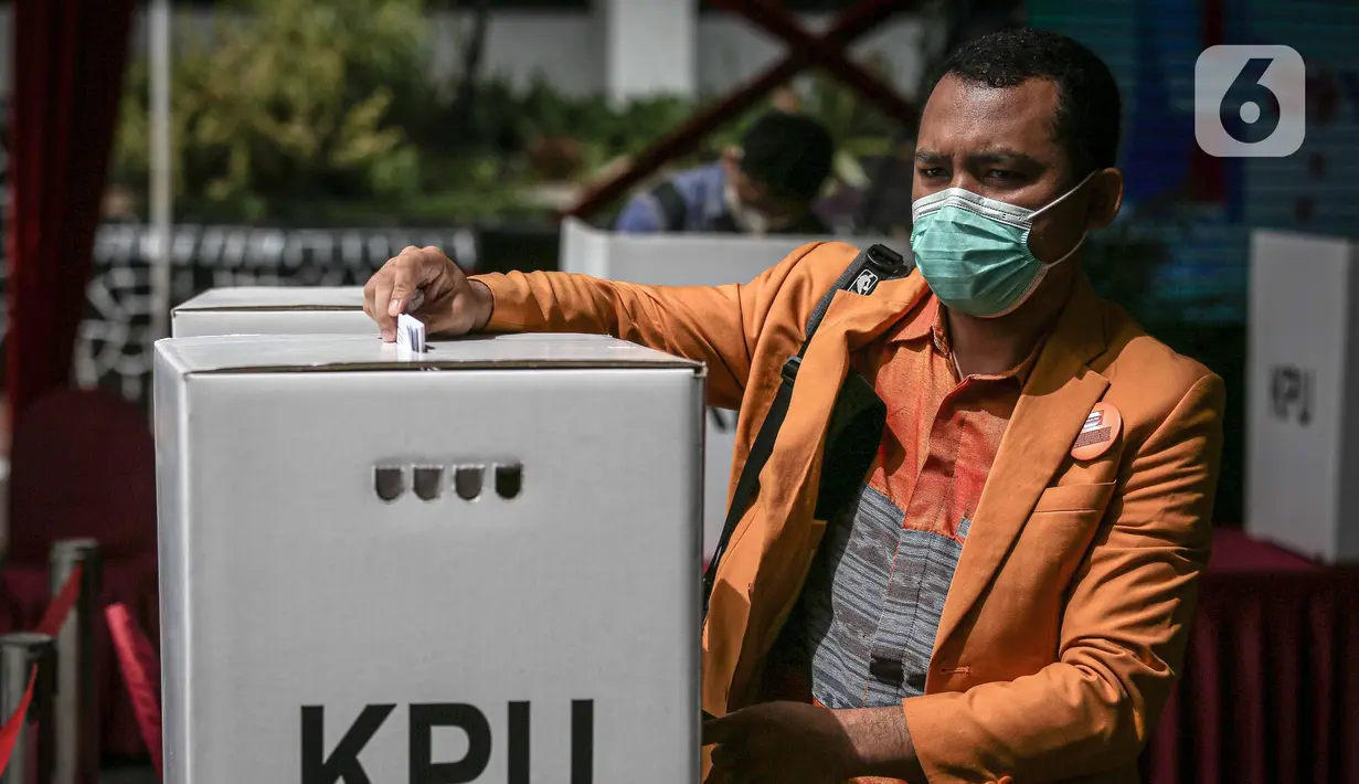 Petugas memasukkan surat suara saat simulasi Pemilu 2024 di Kantor KPU RI, Jakarta, Selasa (22/3/2022). Simulasi  digelar untuk memberikan edukasi kepada masyarakat terkait proses pemungutan dan penghitungan suara pemilu serentak yang akan dilaksanakan tahun 2024. (Liputan6.com/Faizal Fanani)