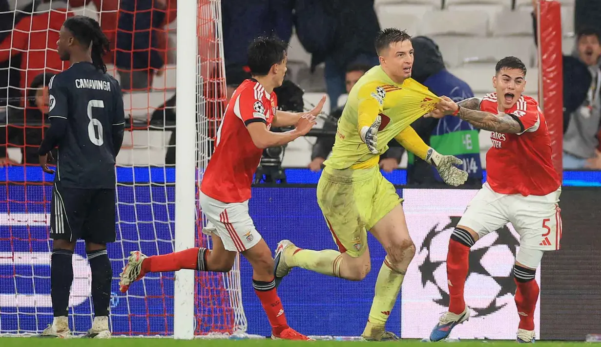 Usai pertandingan, kiper berusia 24 tahun itu mengaku masih sulit mempercayai apa yang baru saja dialaminya. Tampak dalam foto, kiper Benfica asal Ukraina, Anatoliy Trubin (tengah) merayakan gol keempat timnya selama pertandingan pekan ke-8 Liga Champions 2025-2026 melawan Real Madrid di Estadio da Luz, Lisbon, Rabu (28/1/2026) waktu setempat atau Kamis (29/1/2026) dini hari WIB. (PATRICIA DE MELO MOREIRA/AFP)