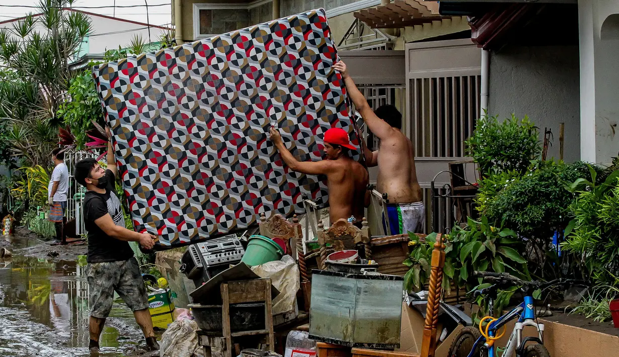 Warga menyelamatkan harta benda usai hujan deras yang dibawa Topan Goni memicu terjadinya banjir di Provinsi Batangas, Filipina, 2 November 2020. Hingga 2 November 2020, jumlah korban jiwa akibat Topan Goni yang melanda bagian selatan Luzon bertambah menjadi 16 orang. (Xinhua/Rouelle Umali)