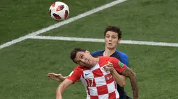 Pemain depan Kroasia Mario Mandzukic (depan) menyundul bola saat berebut dengan bek Prancis Benjamin Pavard pada pertandingan sepak bola final Piala Dunia 2018 di Stadion Luzhniki Moskow, (15/7). (AFP PHOTO / Gabriel Bouys)