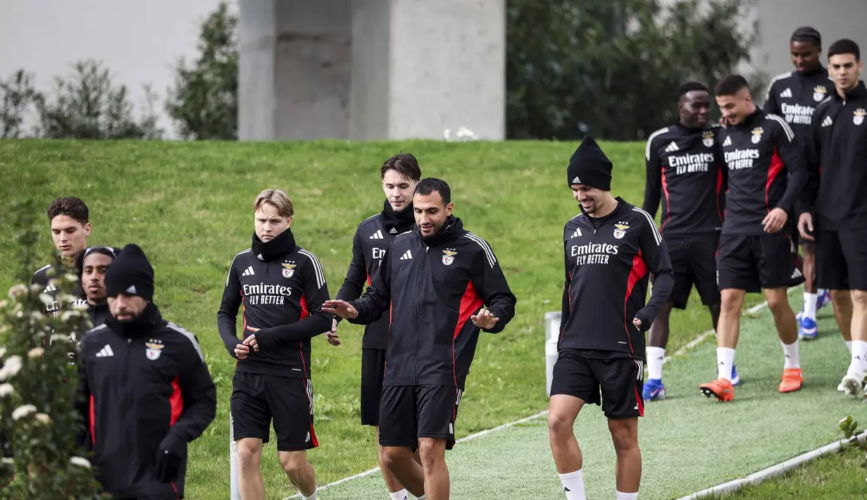 Pertarungan kedua tim ini akan menjadi ajang pembuktian bagi kedua tim yang memiliki ambisi besar di kompetisi paling bergengsi Eropa. Tampak dalam foto, penyerang SL Benfica asal Yunani, Vangelis Pavlidis (tengah) bersama rekan-rekan setimnya berjalan untuk sesi latihan menjelang leg pertama play-off Liga Champions 2025/2026 melawan Real Madrid di Kampus Benfica, Seixal, pinggiran Lisbon, Portugal, pada Senin 16 Februari 2026. (PATRICIA DE MELO MOREIRA/AFP)